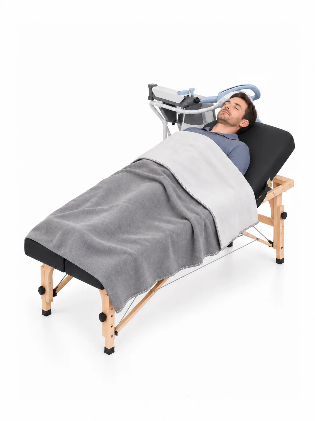 A man reclining on a treatment bed with the EXOMIND coil positioned at his head